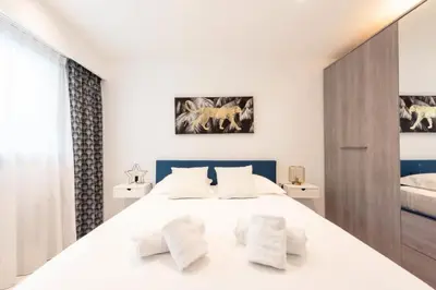 a bedroom with a white bed with two pillows at Résidence Rare ! 3p Piscines, Plages Et Parking - RARE ! 3P piscines, plages et parking MAE-2853 in Cannes