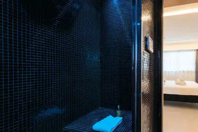 a bathroom with a shower with a blue toilet at Résidence Rare ! 3p Piscines, Plages Et Parking - RARE ! 3P piscines, plages et parking MAE-2853 in Cannes