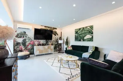 a living room with a couch and a tv at Résidence Rare ! 3p Piscines, Plages Et Parking - RARE ! 3P piscines, plages et parking MAE-2853 in Cannes