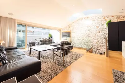 a living room with a brick wall at Résidence Duplex 145m² Terrasse Et Ascenseur Privé - DUPLEX 145m² Terrasse et Ascenseur Privé MAE-2873 in Cannes