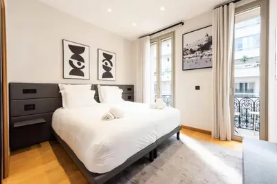a bedroom with a large bed with white sheets at Résidence Duplex 145m² Terrasse Et Ascenseur Privé - DUPLEX 145m² Terrasse et Ascenseur Privé MAE-2873 in Cannes