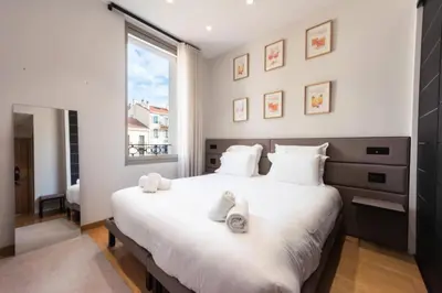 a bedroom with a large white bed with towels on it at Résidence Duplex 145m² Terrasse Et Ascenseur Privé - DUPLEX 145m² Terrasse et Ascenseur Privé MAE-2873 in Cannes