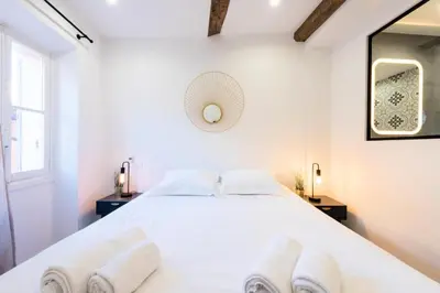 a white bedroom with a white bed with two white towels at Résidence 3p Centre Cannes Suquet - 3P Centre Cannes Suquet MAE-2903 in Cannes