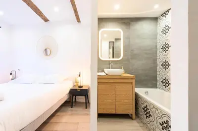 a bedroom with a bed and a sink and a tub at Résidence 3p Centre Cannes Suquet - 3P Centre Cannes Suquet MAE-2903 in Cannes