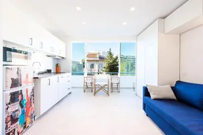 a kitchen and living room with a blue couch at Résidence 2p Au Calme Proche Centre Cannes - 2P au Calme proche Centre Cannes MAE-2983 in Cannes