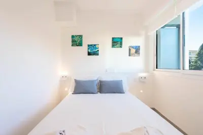 a white bed in a white room with a window at Résidence 2p Au Calme Proche Centre Cannes - 2P au Calme proche Centre Cannes MAE-2983 in Cannes