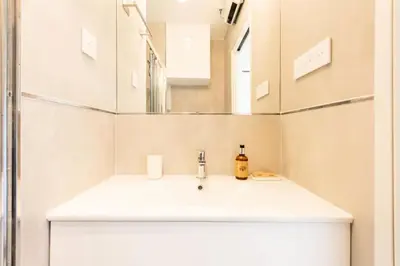 a bathroom with a white sink and a mirror at Résidence 2p Au Calme Proche Centre Cannes - 2P au Calme proche Centre Cannes MAE-2983 in Cannes