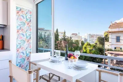 a white dining room with a white table and a large window at Résidence 2p Au Calme Proche Centre Cannes - 2P au Calme proche Centre Cannes MAE-2983 in Cannes