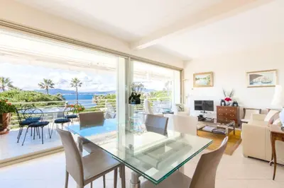 a dining room with a glass table and a view of the ocean at Résidence Vue Mer 95m2 Grande Terrasse Cannes Croisette. - Vue mer 95m2 Grande Terrasse Cannes Croisette. MAE-3003 in Cannes