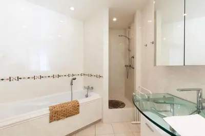 a bathroom with a tub and a glass sink at Résidence Vue Mer 95m2 Grande Terrasse Cannes Croisette. - Vue mer 95m2 Grande Terrasse Cannes Croisette. MAE-3003 in Cannes