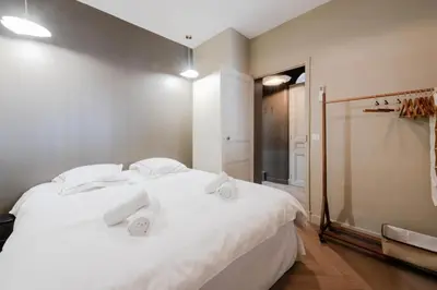 a bedroom with a white bed with towels on it at Résidence 2p Rénové Cœur De Cannes - 2P Rénové Cœur de Cannes MAE-3013 in Cannes