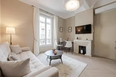 a living room with a white couch and a fireplace at Résidence 2p Rénové Cœur De Cannes - 2P Rénové Cœur de Cannes MAE-3013 in Cannes