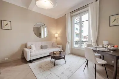 a living room with a white couch and a table at Résidence 2p Rénové Cœur De Cannes - 2P Rénové Cœur de Cannes MAE-3013 in Cannes