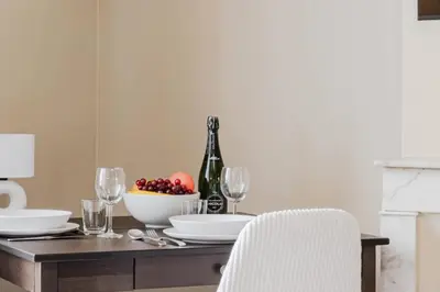 a table with a bottle of wine and a bowl of fruit at Résidence 2p Rénové Cœur De Cannes - 2P Rénové Cœur de Cannes MAE-3013 in Cannes