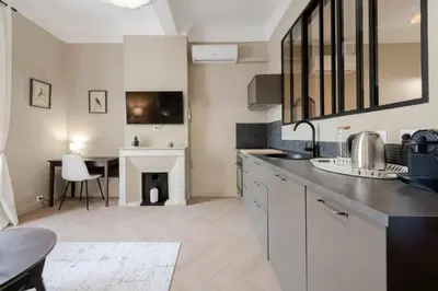 a kitchen with a table and a dining room at Résidence 2p Rénové Cœur De Cannes - 2P Rénové Cœur de Cannes MAE-3013 in Cannes