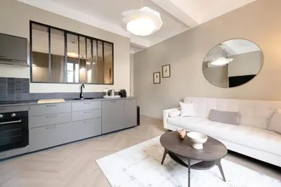 a living room with a white couch and a table at Résidence 2p Rénové Cœur De Cannes - 2P Rénové Cœur de Cannes MAE-3013 in Cannes