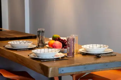 a wooden table with bowls of fruit on it at Résidence 2p Duplex 75m² Avec Piscine - 2P Duplex 75m² avec Piscine MAE-3023 in Cannes