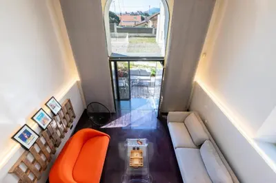 a living room with an orange chair and a couch at Résidence 2p Duplex 75m² Avec Piscine - 2P Duplex 75m² avec Piscine MAE-3023 in Cannes