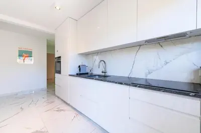 a kitchen with white cabinets and marble counter tops at Résidence Spacieux 3p En Résidence Avec Piscine - Spacieux 3P en Résidence avec Piscine MAE-3033 in Cannes