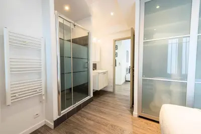 a bathroom with a walk in closet and a mirror at Résidence 2p Centre-ville Cannes Plages à Pied - 2P Centre-Ville Cannes Plages à Pied MAE-3043 in Cannes