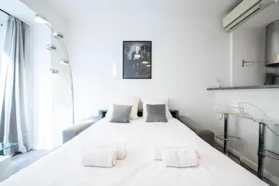 a white bedroom with a large white bed with two pillows at Résidence 2p Centre-ville Cannes Plages à Pied - 2P Centre-Ville Cannes Plages à Pied MAE-3043 in Cannes
