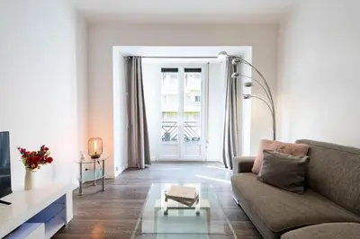 a living room with a couch and a table at Résidence 2p Centre-ville Cannes Plages à Pied - 2P Centre-Ville Cannes Plages à Pied MAE-3043 in Cannes