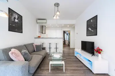 a living room with a couch and a tv at Résidence 2p Centre-ville Cannes Plages à Pied - 2P Centre-Ville Cannes Plages à Pied MAE-3043 in Cannes
