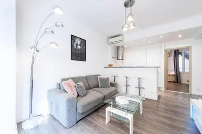 a living room with a couch and a table at Résidence 2p Centre-ville Cannes Plages à Pied - 2P Centre-Ville Cannes Plages à Pied MAE-3043 in Cannes
