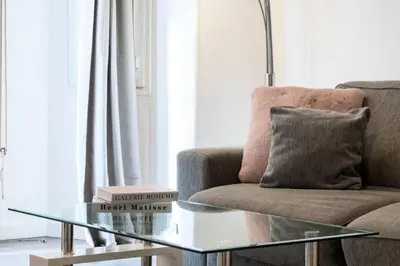 a living room with a couch and a glass coffee table at Résidence 2p Centre-ville Cannes Plages à Pied - 2P Centre-Ville Cannes Plages à Pied MAE-3043 in Cannes