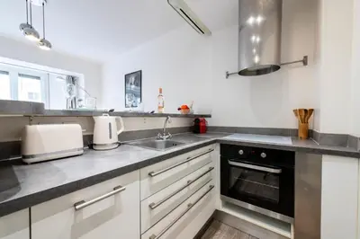 a kitchen with white cabinets and a sink at Résidence 2p Centre-ville Cannes Plages à Pied - 2P Centre-Ville Cannes Plages à Pied MAE-3043 in Cannes
