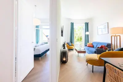 a living room with a blue couch and a bedroom at Résidence 3p Avec Balcons, 3min Du Palais Des Congrès - 3P avec Balcons, 3min du Palais des congrès MAE-3053 in Cannes