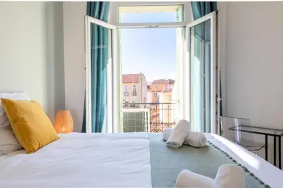 a bedroom with a white bed with a large window at Résidence 3p Avec Balcons, 3min Du Palais Des Congrès - 3P avec Balcons, 3min du Palais des congrès MAE-3053 in Cannes
