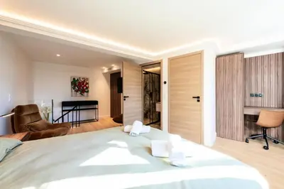a bedroom with a large bed and a living room at Résidence 2p En Duplex De Standing Au Calme - 2P en Duplex de Standing au Calme MAE-3063 in Cannes