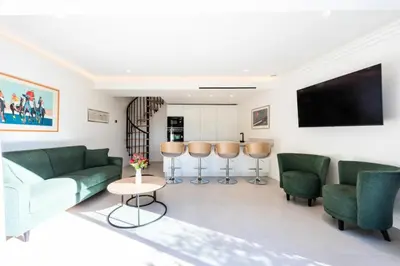 a living room with green furniture and a flat screen tv at Résidence 2p En Duplex De Standing Au Calme - 2P en Duplex de Standing au Calme MAE-3063 in Cannes