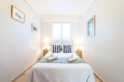 a bedroom with a bed with two pillows on it at Résidence Rez-de-jardin Croisette Vue Mer Avec Garage - Rez-de-jardin Croisette vue mer avec garage MAE-3083 in Cannes