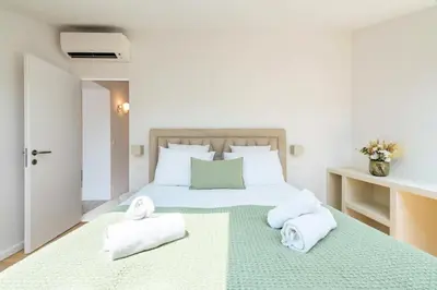 a bedroom with a large bed with towels on it at Résidence 4p Duplex Mansardé, Cœur De Cannes - 4P Duplex Mansardé, Cœur de Cannes MAE-3103 in Cannes