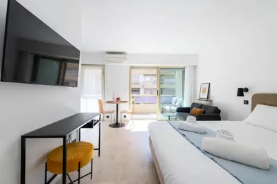 a living room with a couch and a table at Résidence Studio Terrasse 2 Min De La Croisette - Studio Terrasse 2 min de la Croisette MAE-3113 in Cannes