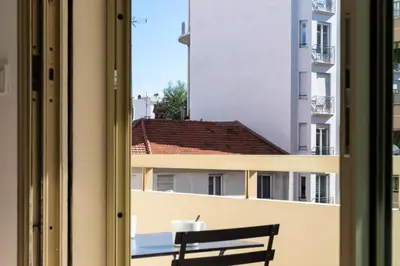 a bench sitting on a balcony looking out a window at Résidence Studio Terrasse 2 Min De La Croisette - Studio Terrasse 2 min de la Croisette MAE-3113 in Cannes
