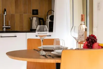 a table with two wine glasses and fruit on it at Résidence Studio Terrasse 2 Min De La Croisette - Studio Terrasse 2 min de la Croisette MAE-3113 in Cannes