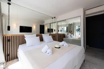 a bedroom with a large white bed with towels on it at Résidence Grand 2p Rénové Terrasse Cœur De Cannes - Grand 2P rénové Terrasse Cœur de Cannes MAE-3143 in Cannes