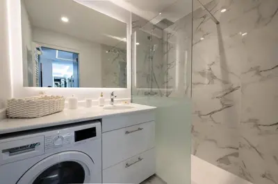 a bathroom with a washing machine and a shower at Résidence Grand 2p Rénové Terrasse Cœur De Cannes - Grand 2P rénové Terrasse Cœur de Cannes MAE-3143 in Cannes
