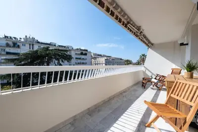a balcony with chairs and a table on a building at Résidence Grand 2p Rénové Terrasse Cœur De Cannes - Grand 2P rénové Terrasse Cœur de Cannes MAE-3143 in Cannes