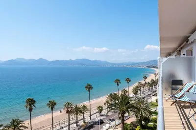 a view of the beach from the balcony of a hotel at Résidence Cannes – Suquet Vue Mer & Accès Plage - Cannes – Suquet Vue Mer & Accès Plage MAE-3163 in Cannes