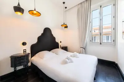 a bedroom with a large white bed and a window at Résidence Prestige Et Confort Face Au Palais Des Festivals - Prestige et Confort Face au Palais des Festivals MAE-3173 in Cannes