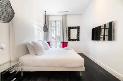 a white bedroom with a white bed and a window at Résidence Prestige Et Confort Face Au Palais Des Festivals - Prestige et Confort Face au Palais des Festivals MAE-3173 in Cannes
