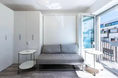 a bed in a room with a large window at Résidence Appartement Lumineux Centre Cannes - Appartement lumineux Centre Cannes MAE-3193 in Cannes
