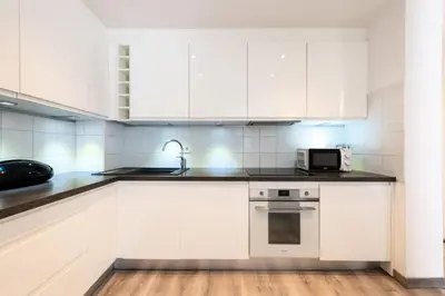 a kitchen with white cabinets and a microwave at Résidence Appartement Lumineux Centre Cannes - Appartement lumineux Centre Cannes MAE-3193 in Cannes