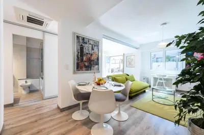 a white living room with a table and chairs at Résidence Appartement Lumineux Centre Cannes - Appartement lumineux Centre Cannes MAE-3193 in Cannes