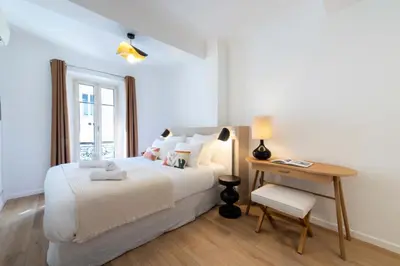 a bedroom with a bed and a table and a desk at Résidence 3p Terrasse & Calme Cannes Centre - 3P Terrasse & Calme Cannes Centre MAE-3213 in Cannes
