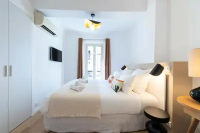 a bedroom with a bed with a teddy bear on it at Résidence 3p Terrasse & Calme Cannes Centre - 3P Terrasse & Calme Cannes Centre MAE-3213 in Cannes